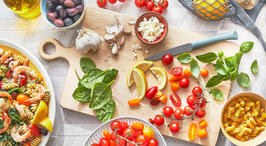 Ingredients of shrimp pasta salad on kitchen surface