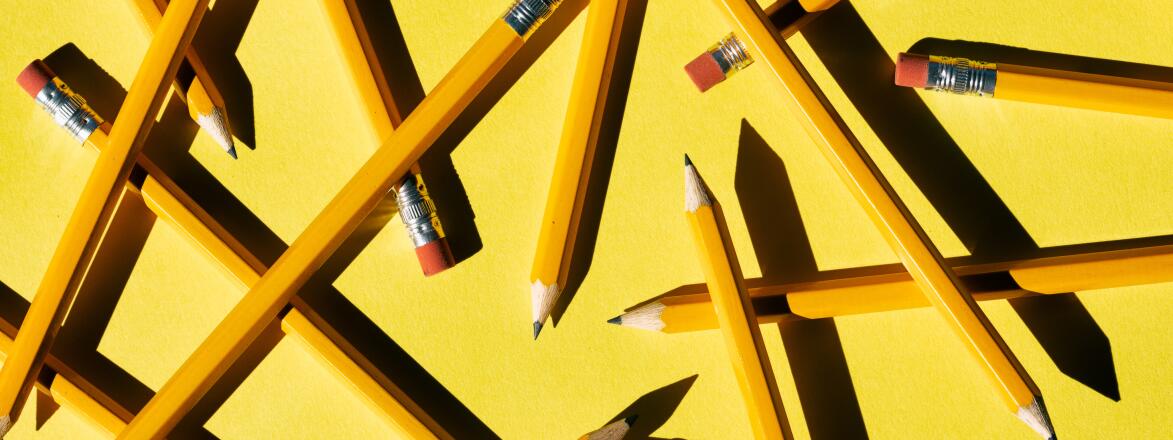 Layers Of Pencils Scattered On yellow Paper