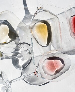 Wine Glasses on a white surface with With Different Types Of Wine inside