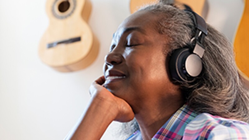 A woman listening to something with headphones on