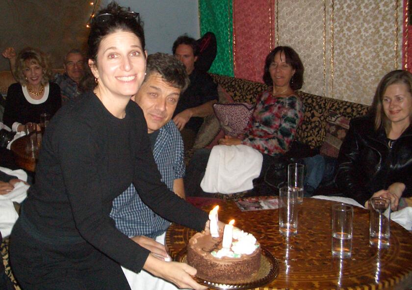 Gayle Kirschenbaum holds her cake as she celebrates her 50th birthday with friends and family