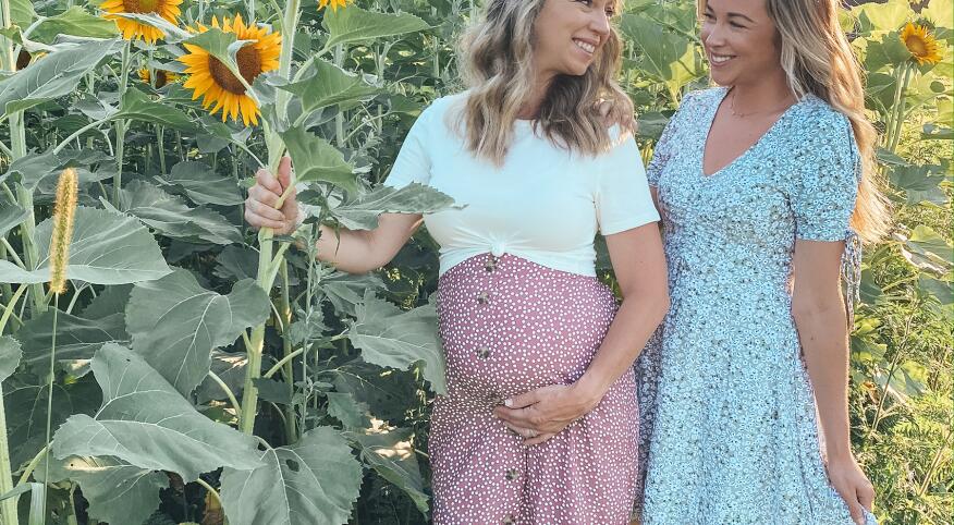 51 year old Mother who is a surrogate for her daughter. Photographed in a field of sunflowers.
