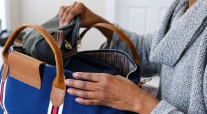 Woman packs carry on bag preparing for travel