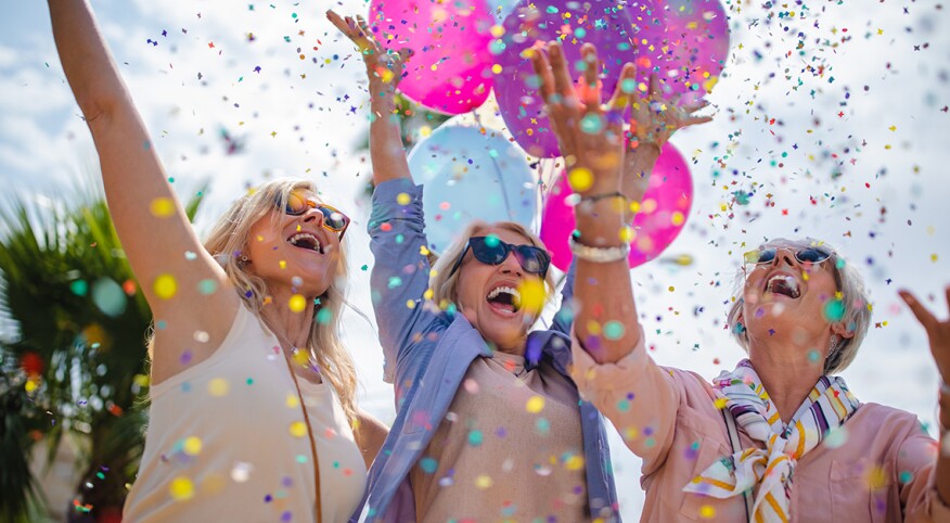 image of women celebrating with balloons and confetti
