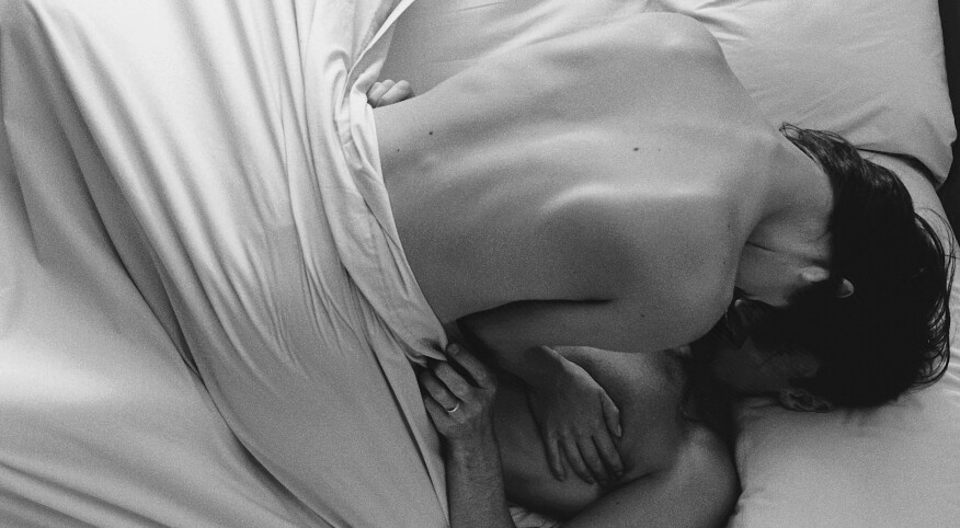 black and white photo of a man and woman in bed