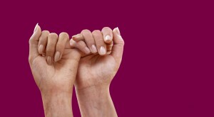 Two female hands doing a pinky swear-promise