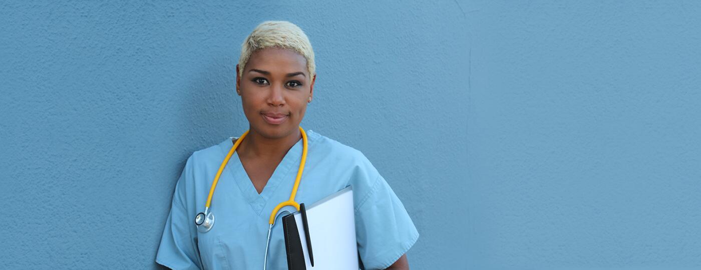 Black female doctor in blue scrubs