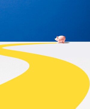 Piggy bank in front of blue and yellow background