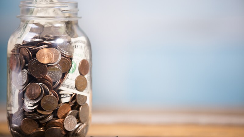 Money jar with U.S. currency. Savings, donations concepts.