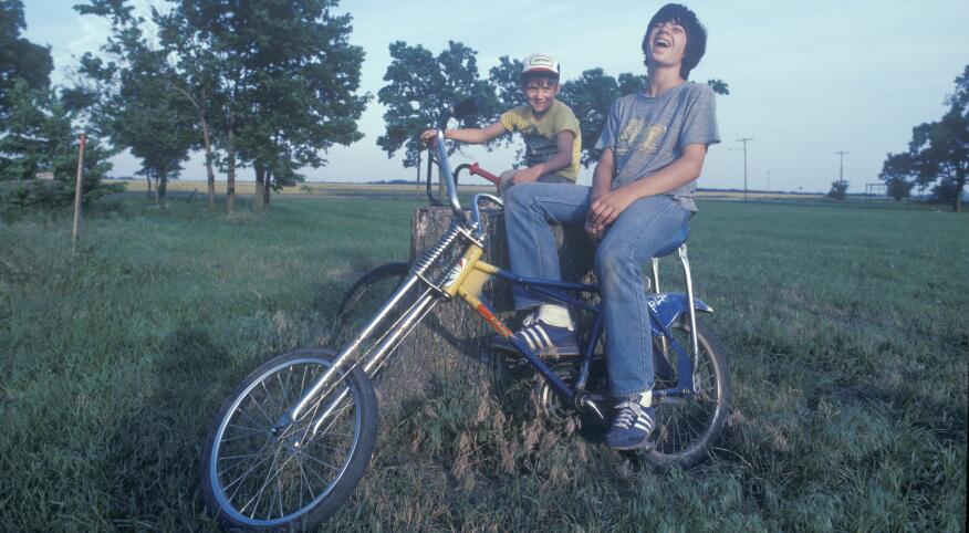 two kids on bikes in the 1980s