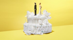 Wedding cake made out of tampons with bride and groom figurines on top.