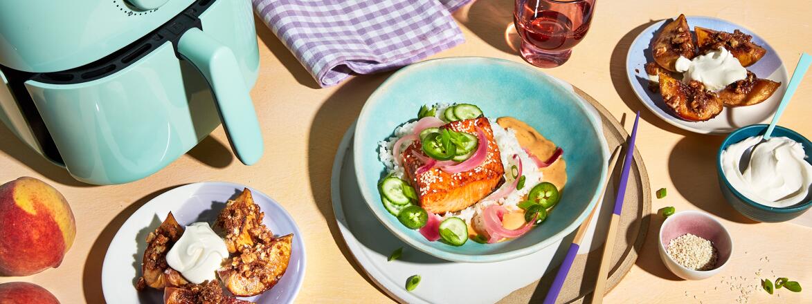 A teal air fryer with two recipes poke and baked apples