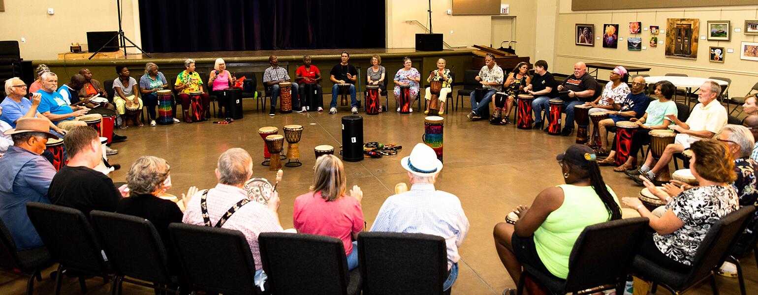 image_of_group_of_people_sitting_in_a_large_circle_with_drums_and_instruments_DrumCirlces_SistersFromAARP_DeannaReid-7380_1540.jpg