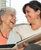 Adult child sharing moment with senior mom