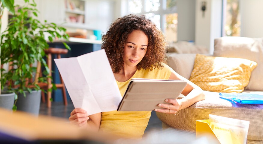 Woman at home reviewing paperwork