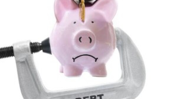 Piggy bank in debt vice grip