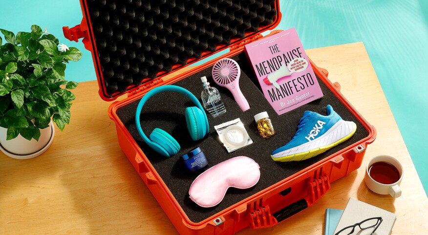 Various items including lube, sneakers, a fan and sleep mask in a safe foam case sitting on a table at home