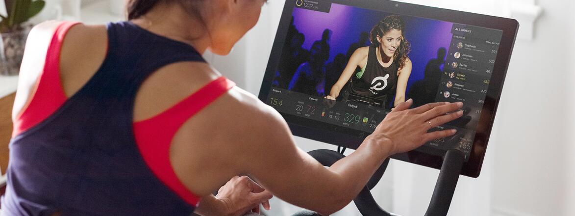 An image of a woman cycling during a Peloton class.