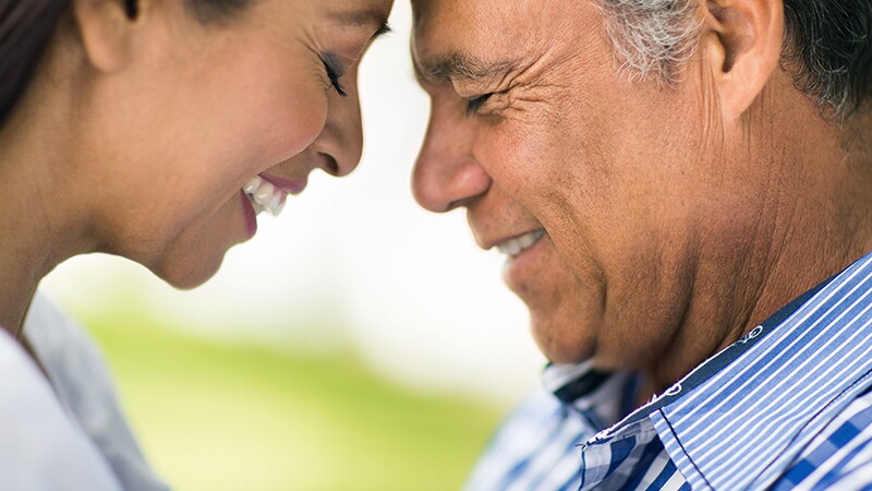 An up-close view of a man and woman with their heads touched together