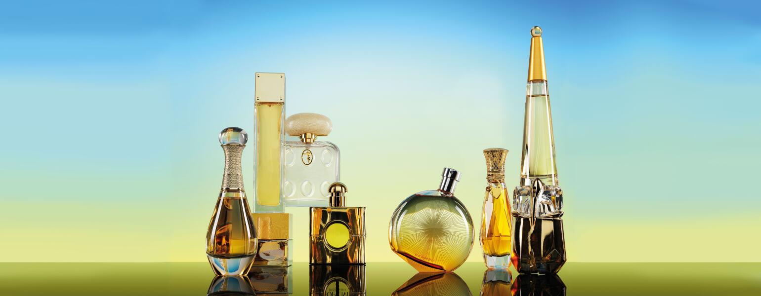 Seven Perfume bottles on a gradient blue to yellow background