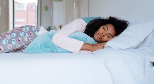 image_of_woman_sleeping_in_bed_GettyImages-896809536_1800