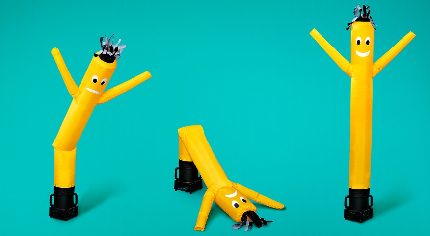 Yellow inflatable men on aqua background