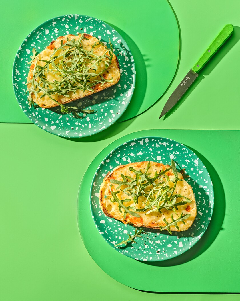 Two slices of West Coast toast from above on bright green background.