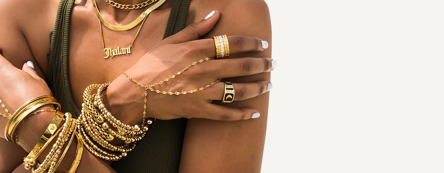 image of black woman layers of gold jewelry