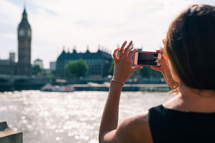 Woman taking photos in London