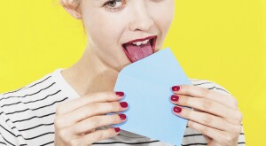 An image of a woman licking a letter envelope.