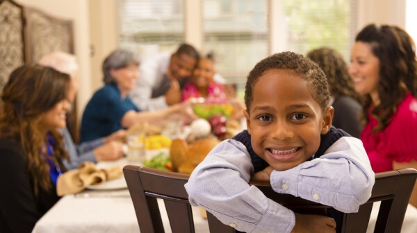 Young Boy Smiling at Table