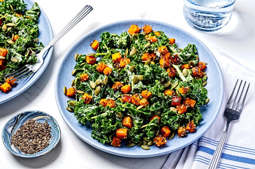 Kale salad recipe on a blue plate for a healthy New Year