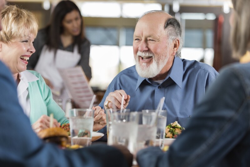 Older man in conversation at restaurant