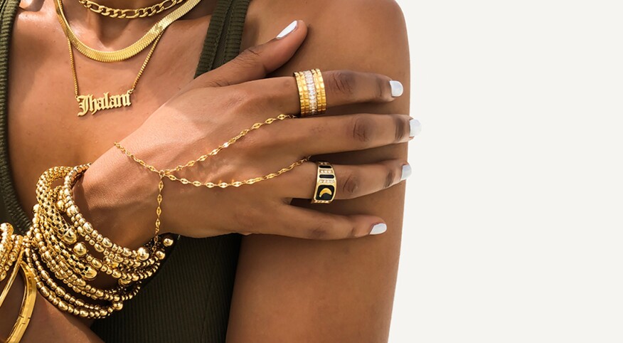 Black woman with layers of gold jewelry