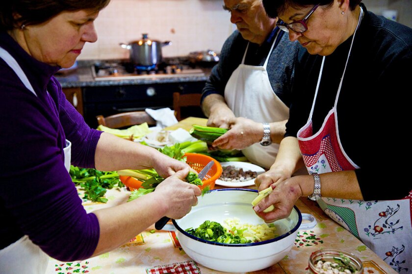 Family prepares a meal in Sardinia