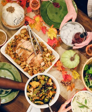 Overhead image of multiple people enjoying a Thanksgiving dinner