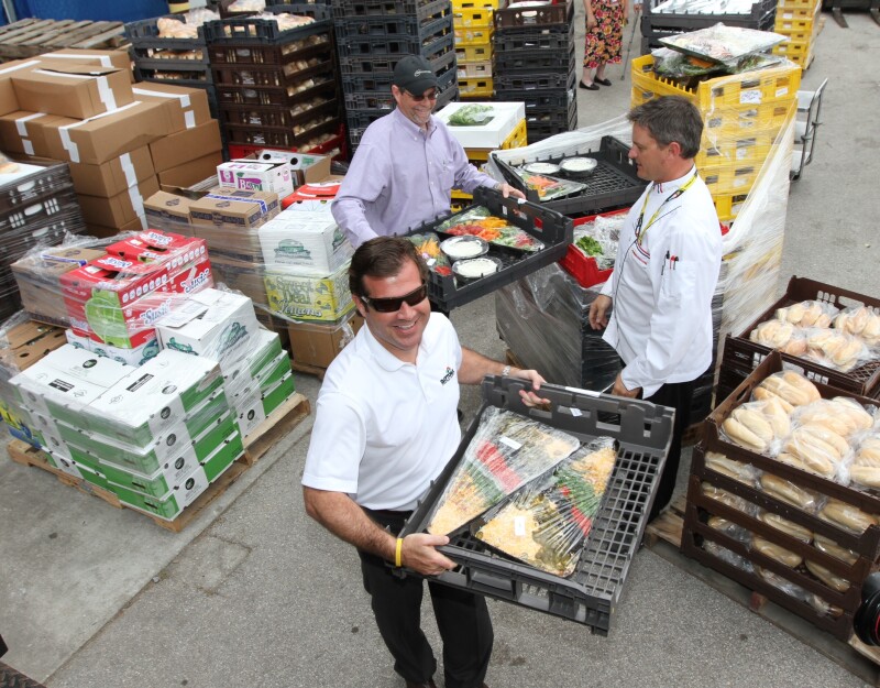 Volunteers collect food from Daytona Speedway Monday.