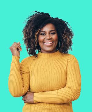 Portrait of smiling beautiful Afro woman standing against white background