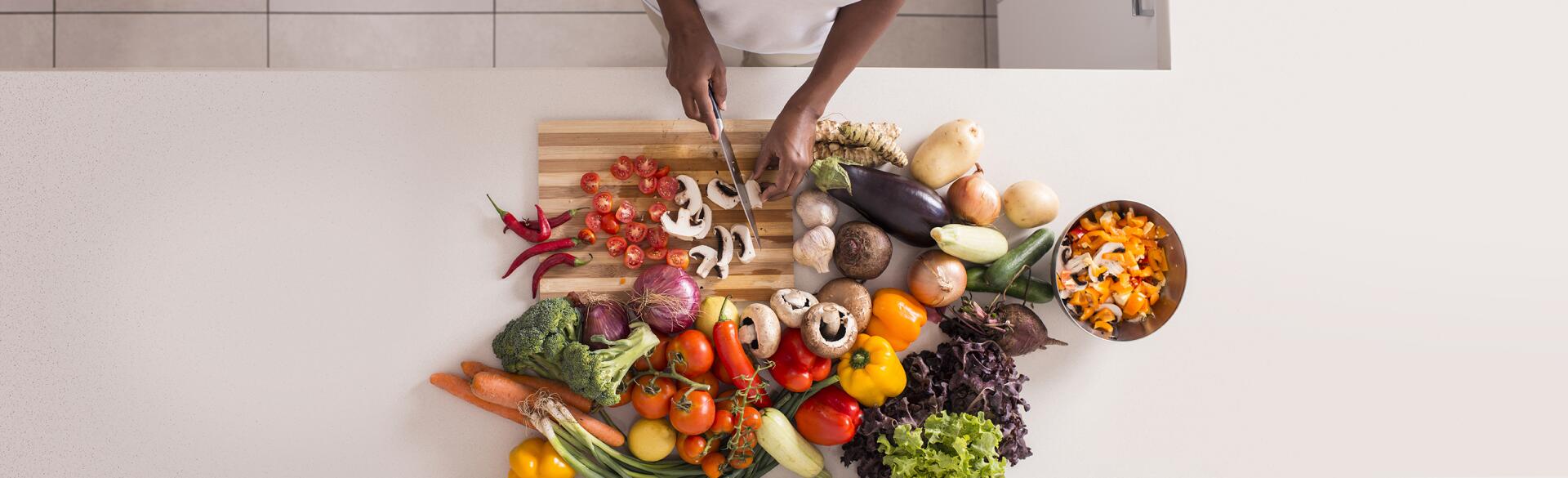 Unrecognized women preparing fresh healthy salad.