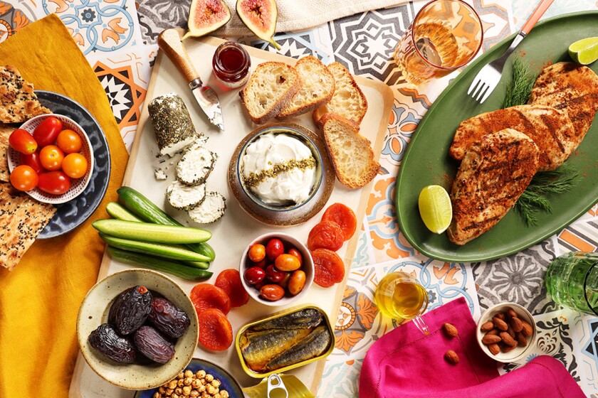 Overhead shot of charcuterie board styled with bright tablewear