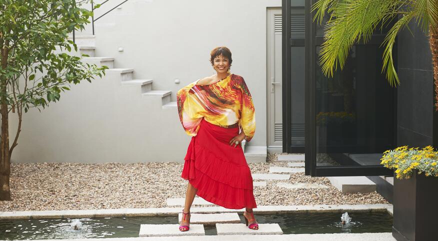 Hispanic woman standing on steps over pond