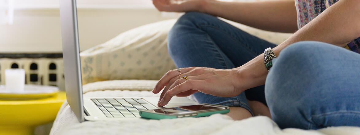 Woman Practicing Meditation On Bed At Laptop
