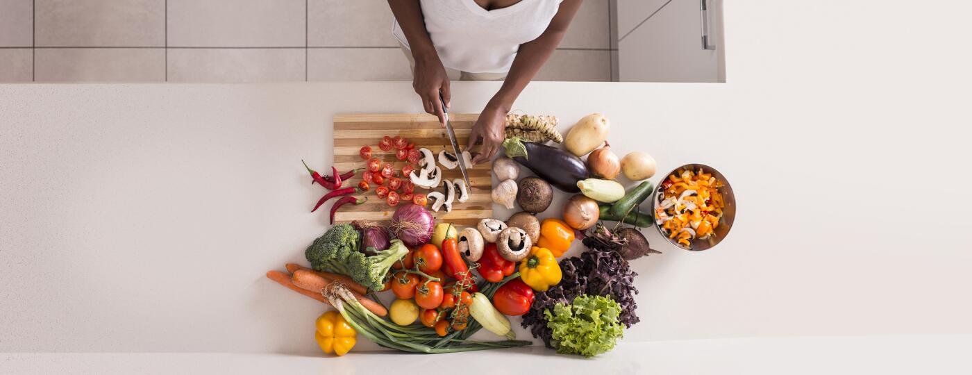 Unrecognized women preparing fresh healthy salad.
