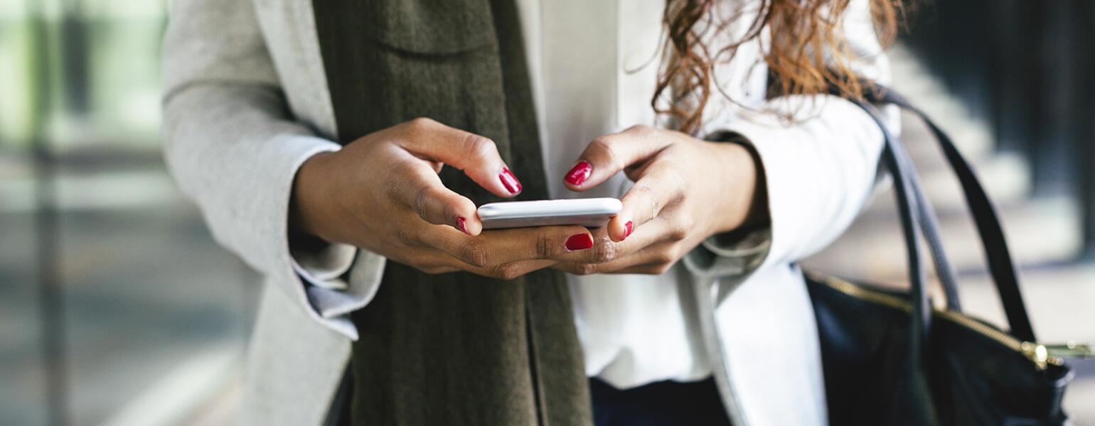 image_of_woman_hands_using_phone_offset_comp_300588_1540