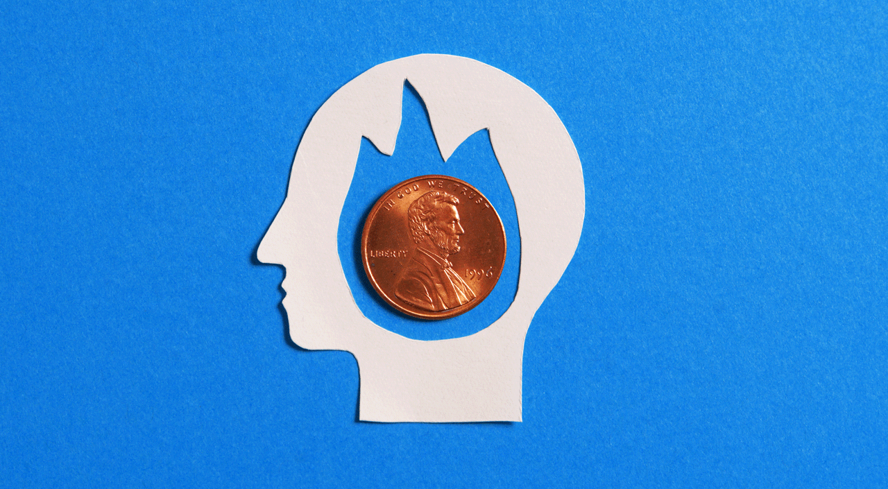 Cut out of a paper face with a penny inside