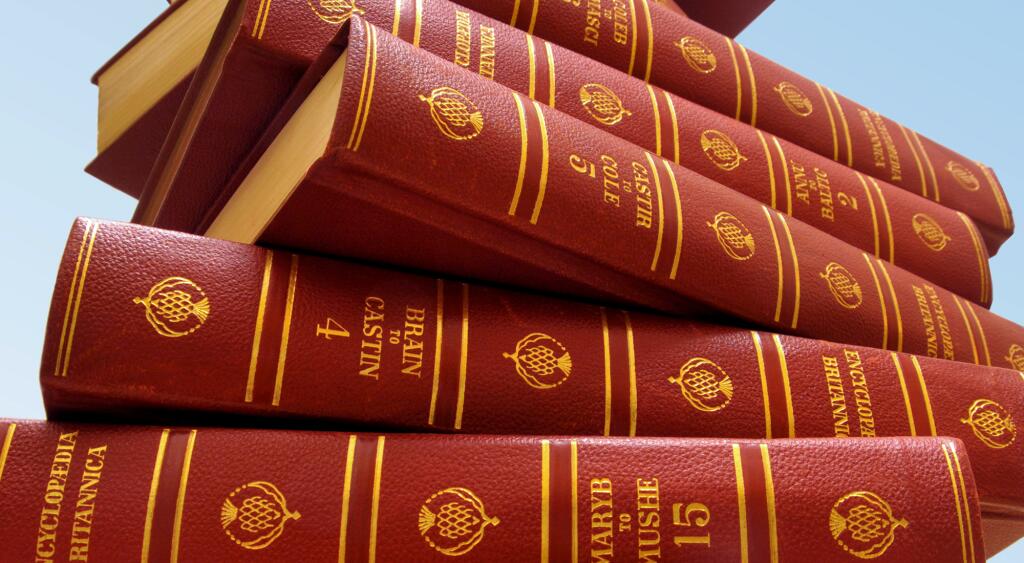stack of encylopedia britanicas on a blue background