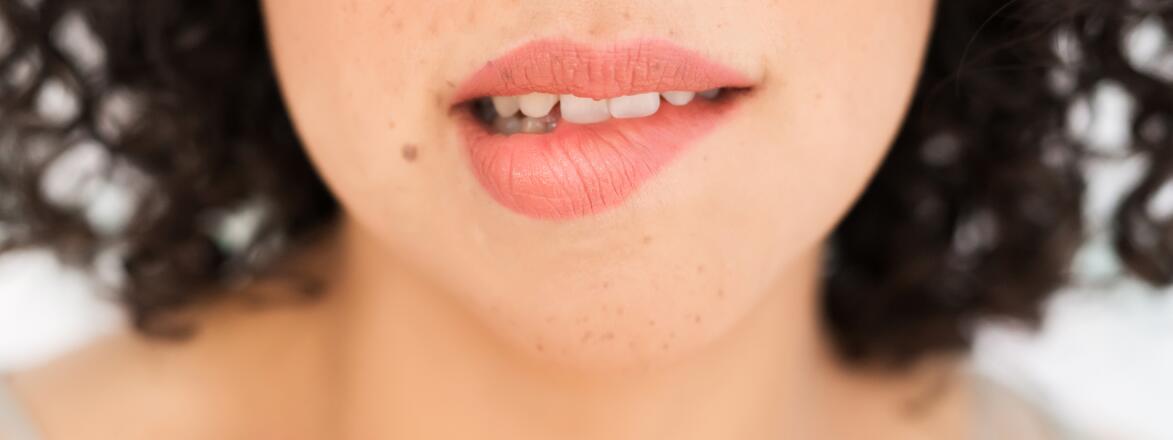 Up Close Of A Woman biting her lip
