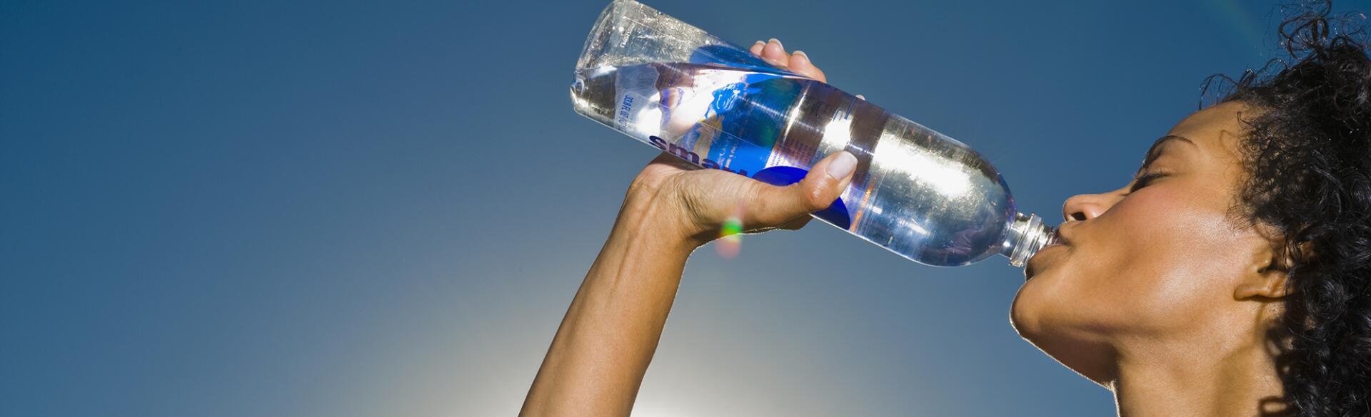 African woman drinking water