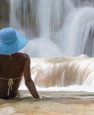 image of woman sitting in front of waterfall