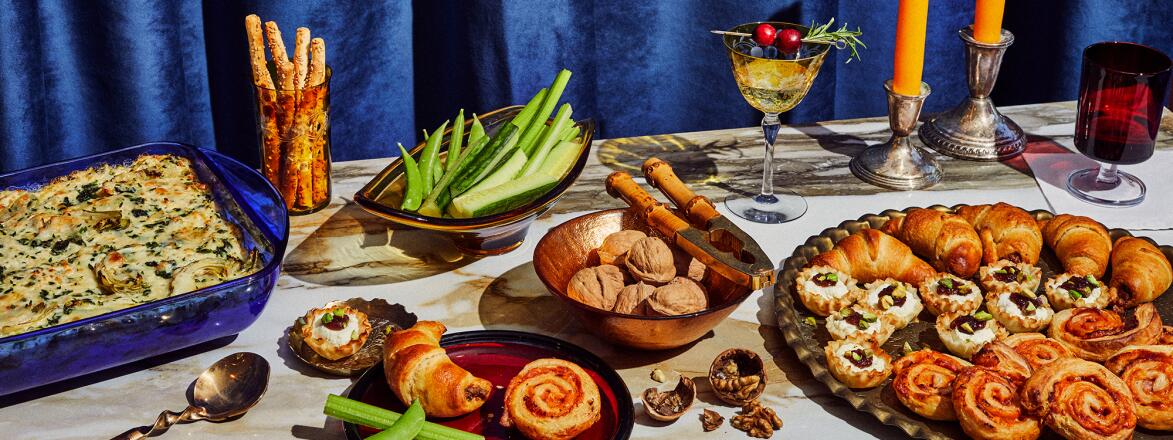 Four appetizers on a decorated table set for the winter holidays